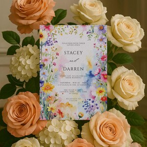 May include: A wedding invitation featuring floral watercolor artwork with the names "Stacey and Darren". The invitation is surrounded by peach and cream roses and white hydrangeas. The text includes the wedding date, time, and location.
