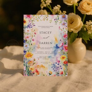 May include: A floral wedding invitation with the names "Stacey and Darren" in a watercolor design. The invitation includes details for the wedding at The Tulip Garden, Central Park, New York, on May 22, 2028.