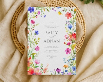 May include: A floral wedding invitation with the names "SALLY" and "ADNAN" in elegant script. The invitation is framed by a watercolor design of colorful flowers, including pink, blue, and red blooms. The text includes the date, time, and location.