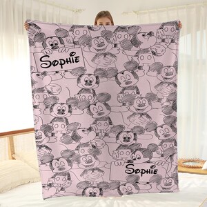 Puede incluir: Una taza de cer&aacute;mica blanca con un asa negra y el texto "But First, Coffee" en negrita negra. La taza se encuentra sobre un fondo borroso, sugiriendo un ambiente acogedor.