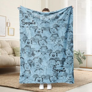 Puede incluir: Una taza de cer&aacute;mica blanca con un asa negra y el texto "But First, Coffee" en negrita negra. La taza est&aacute; sobre un fondo borroso. La taza mide aproximadamente 10 cm de altura.