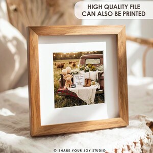 May include: A framed print with a rustic theme. The print features a vintage truck bed filled with flowers, balloons, and a stuffed cow. Text on the print reads "Holy Cow!" and "Baby Williams is due". The frame is made of light-colored wood.