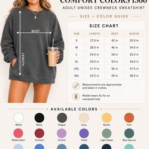 May include: A dark gray crewneck sweatshirt with long sleeves and a size chart displaying measurements in inches for sizes S through 3XL. The image includes a color guide with twenty-four circular swatches labeled with names like White, Black, Pepper, and Blue Spruce.