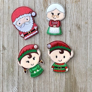 May include: Four Christmas-themed felt appliques: Santa Claus, Mrs. Claus, and two elves. Santa wears a red suit with a white beard and black belt. Mrs. Claus is in a red dress and apron. The elves are in green and red outfits.