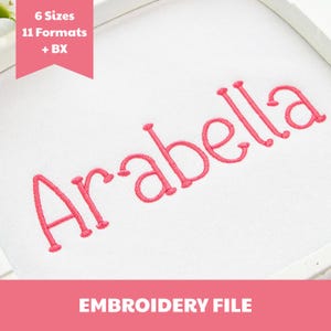 May include: An embroidery file featuring the name Arabella stitched in pink thread on a white fabric background. A pink banner in the top left corner displays the text 6 Sizes 11 Formats + BX, and the bottom banner displays EMBROIDERY FILE.
