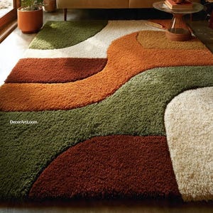 May include: A shag rug with a retro design in shades of green, orange, brown, and cream. The rug is in a living room setting with a beige sofa, plants, and a glass-topped table. The text "DecorArtLoom" is visible.