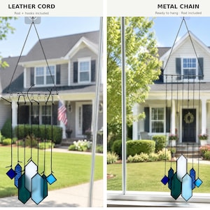 May include: Two hanging suncatchers featuring geometric stained glass pieces in shades of blue and white. The left version uses a black leather cord, while the right version uses a black metal chain. Both include a rod and hooks for hanging.