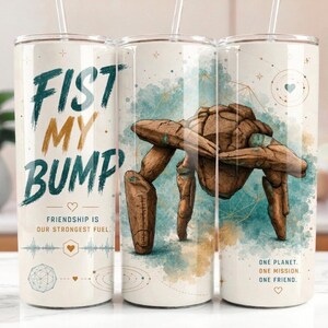 May include: A cylindrical tumbler with a straw featuring a brown rock-like creature performing a fist bump. The text reads FIST MY BUMP, FRIENDSHIP IS OUR STRONGEST FUEL, and ONE PLANET. ONE MISSION. ONE FRIEND. It includes blue and gold watercolor accents.