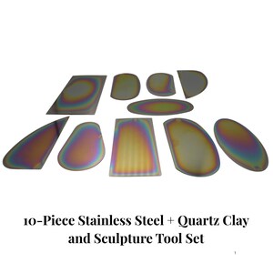 May include: A set of ten stainless steel and quartz clay sculpture tools. The tools have a metallic, iridescent finish with various shapes, including rectangles, ovals, and teardrops. The text at the bottom reads: 10-Piece Stainless Steel + Quartz Clay and Sculpture Tool Set.