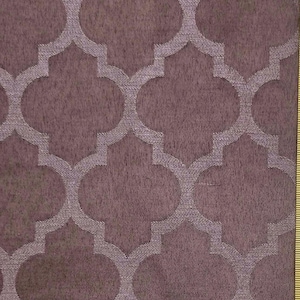 May include: A fabric swatch featuring a repeating quatrefoil pattern in a deep mauve or plum shade. The design consists of interconnected, rounded geometric shapes that create a continuous lattice effect across the textured material surface.