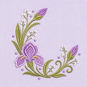 May include: An embroidery design featuring a central purple iris flower with yellow accents, surrounded by green stems, leaves, and small white buds. The floral arrangement is curved in a crescent shape, accented by scattered purple dots on a light purple fabric.