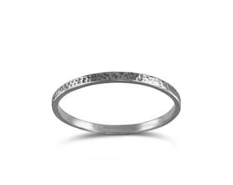 May include: A silver-colored ring with a textured surface. The ring is a simple band design, suitable for everyday wear. The ring's surface has a hammered or distressed appearance, adding a unique touch to the jewelry.