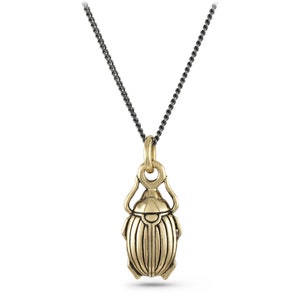 May include: A gold-toned scarab beetle pendant necklace with a black chain.