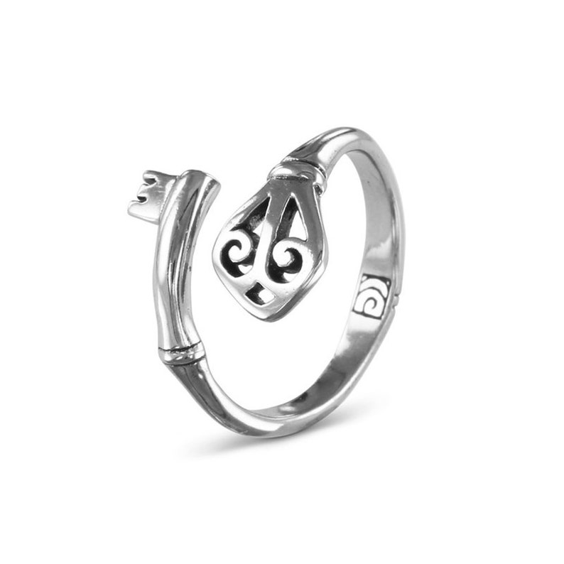 May include: A silver key ring with a detailed key design. The ring is open and ready to be worn.