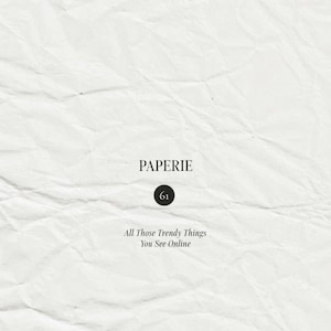 May include: A white, textured, creased paper background featuring centered black text that reads PAPERIE, followed by a black circle containing the number 61, and the phrase All Those Trendy Things You See Online in a serif font.
