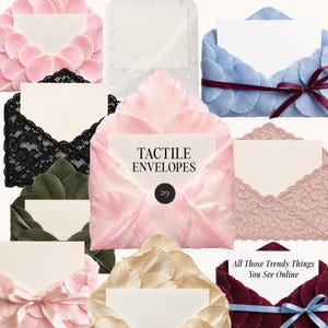 May include: A collection of decorative envelopes featuring various textures and embellishments, including pink and blue petal-like layers, black and dusty rose lace, white pearls, and satin ribbons. One envelope displays the text TACTILE ENVELOPES 29.