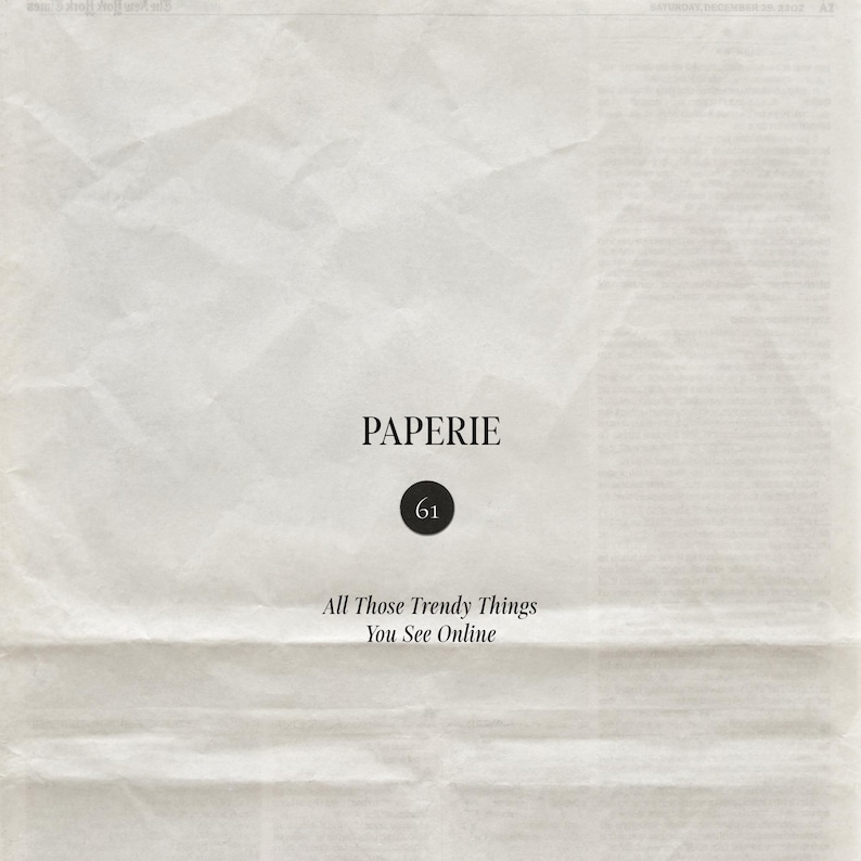 May include: A piece of off-white, textured, creased paper featuring the black text PAPERIE, a black circle containing the number 61, and the text All Those Trendy Things You See Online centered in a serif font on the surface.