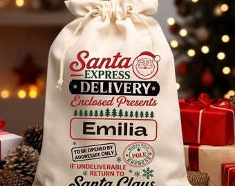 May include: A cream-coloured Santa Claus gift bag with a drawstring closure. The bag features the text "Santa Express Delivery" and "Emilia" in red and black. Presents and a Christmas tree are in the background.