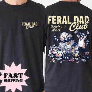 May include: Black t-shirt with "FERAL DAD Club" printed on the front and back. The back features a graphic of raccoons around a trash can with the text "thriving in chaos."