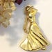 Christina Gaudet-Pelletier reviewed Golfing Lady Brooch Vintage Fort Victorian Woman Golfer Pin 1980s Gold Tone Collectible Golf Gift Old Fashioned Lady Golfer in Dress and Hat