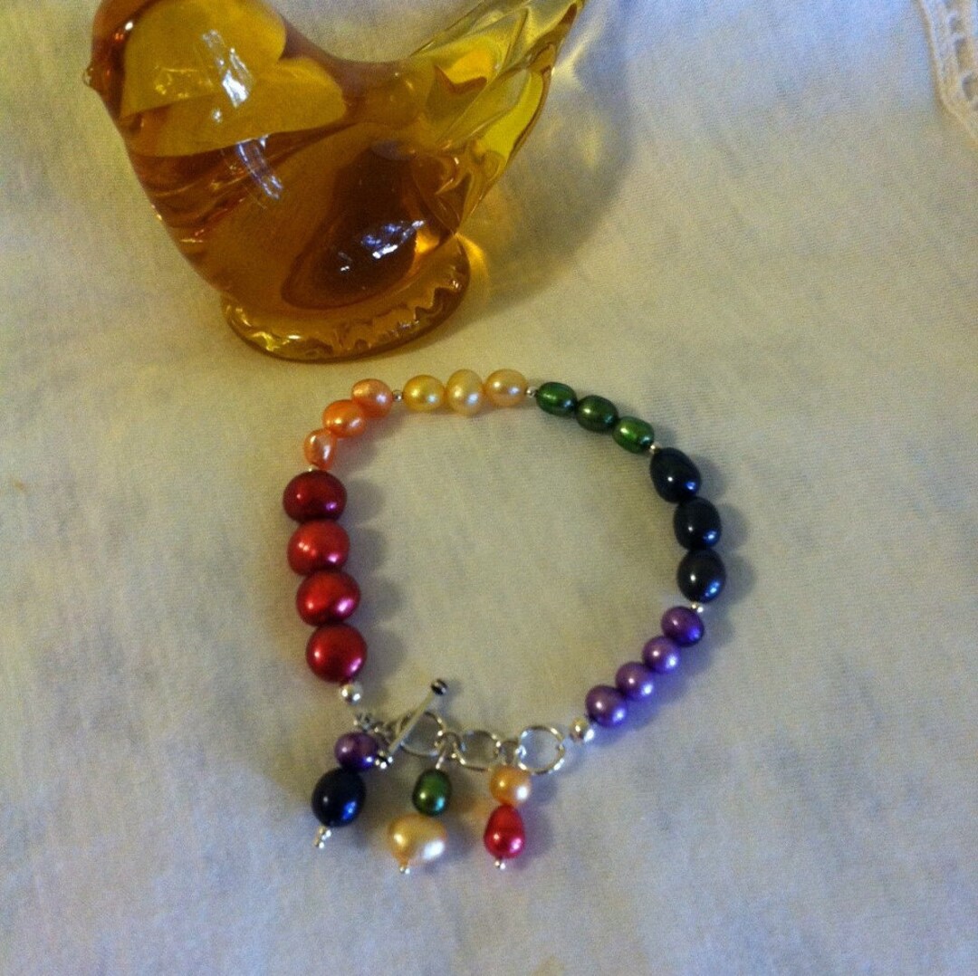 Pearl Bracelet with Rainbow Charm. main image 1