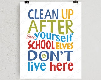 May include: A white poster with the text "CLEAN UP AFTER yourself SCHOOL ELVES DON'T live here" in various colors. The poster is held by two black binder clips.