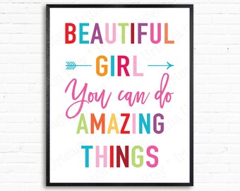 May include: A colorful motivational poster with the text "Beautiful Girl You can do Amazing Things" in a rainbow of colors. The text is framed by a black frame.