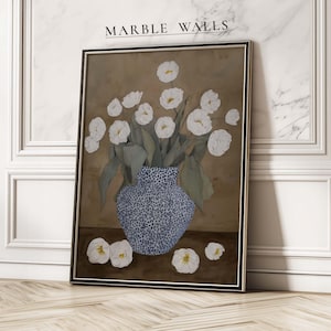 May include: A framed floral art print featuring a blue and white patterned vase filled with white flowers and green leaves. The artwork is set against a brown background, with the text "MARBLE WALLS" at the top.