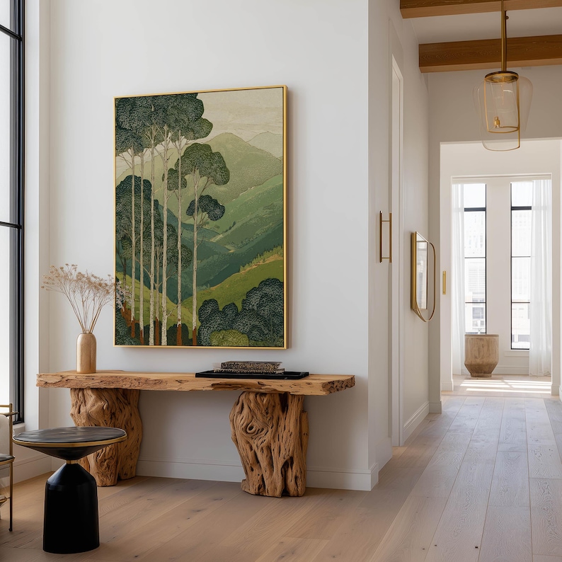 Forest trees over soft green mountains in a minimalist, calming wall art print, hung in a bright hallway above a rustic console.
