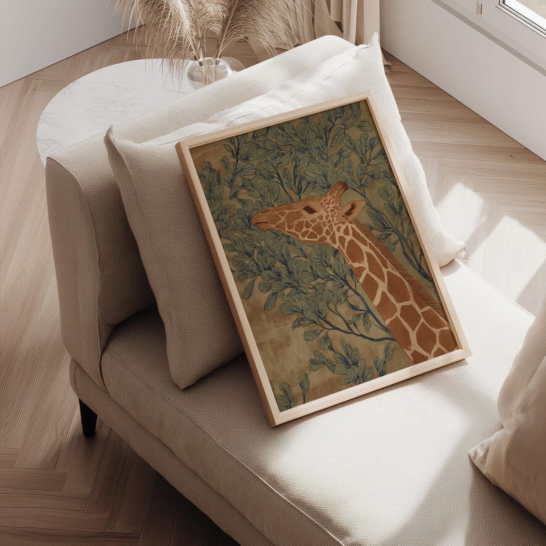 Whimsical giraffe botanical scene in green and brown, warm and quiet mood, styled as a framed wall art print on a cushioned chair by a side table.