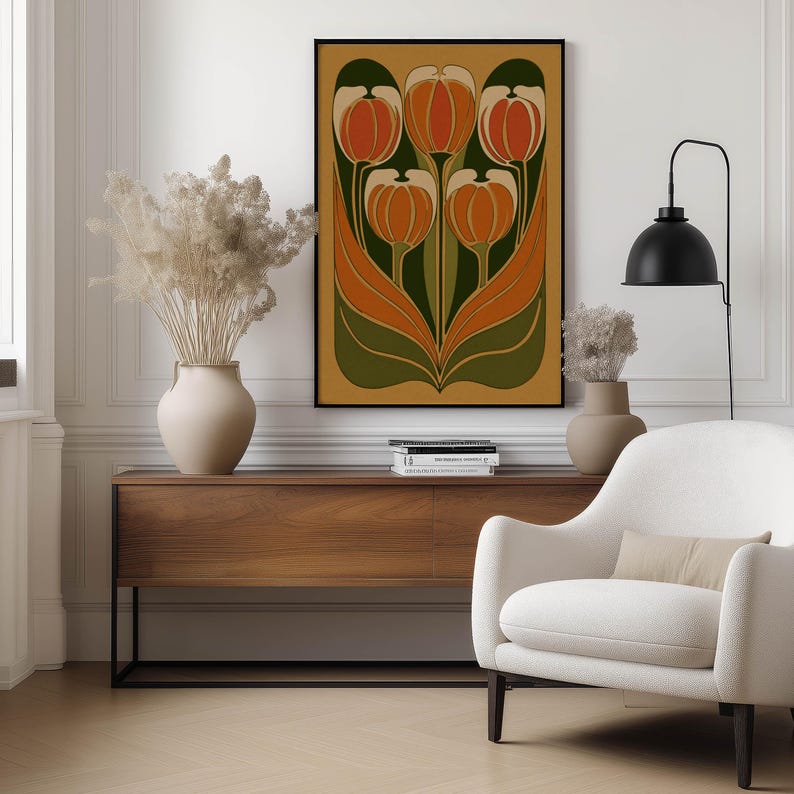 Earthy orange and green tulip illustration with flowing leaves art print hung above a wooden console table with neutral vases and a cozy armchair.