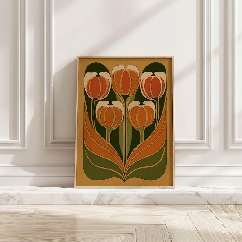 Bold vintage tulip illustration in orange and green on a mustard ground wall art print framed and leaning against a white paneled marble wall.