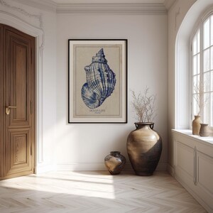 Antique-style blue seashell poster on beige textured paper, a framed wall art print in a bright hallway next to two large decorative floor vases.