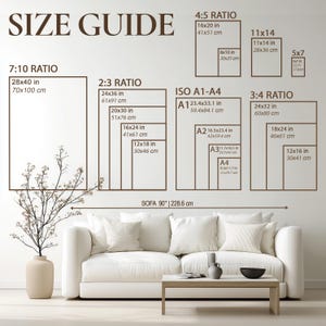May include: A size guide chart with various rectangular dimensions in inches and centimeters. The chart includes ratios like 7:10, 2:3, 4:5, and 3:4, along with ISO A1-A4 sizes. A white sofa is positioned below the chart.