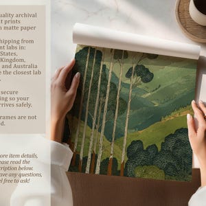 Green mountain landscape with tall trees in a calm, vintage-style art print, shown being unrolled on a tabletop with matte paper info panel.