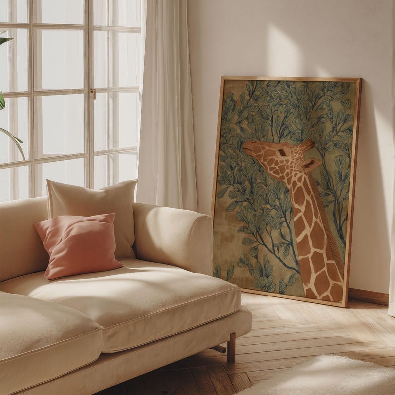 Earthy giraffe and leaf illustration in green and brown, soft vintage mood, styled as a framed art print leaning by a sofa with warm afternoon light.