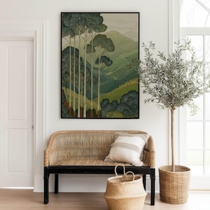 Layered green hills and slender forest trees in a vintage-style, soothing poster, styled above a woven bench in a bright entryway.