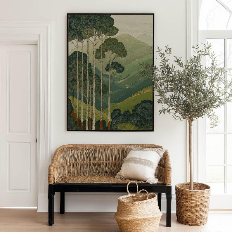 Layered green hills and slender forest trees in a vintage-style, soothing poster, styled above a woven bench in a bright entryway.