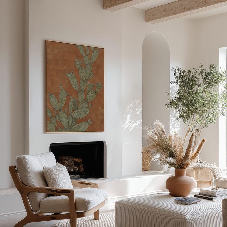 Prickly pear cactus illustration in sage green and terracotta, vintage botanical vibe, shown as a framed art print on a neutral lounge wall.