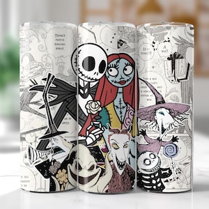 May include: Three tall, cylindrical tumblers feature illustrations of characters from The Nightmare Before Christmas. Jack Skellington, Sally, and other characters are depicted in a black and white comic book style. The tumblers are on a white surface.