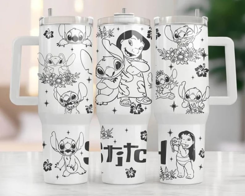 May include: White tumbler with a handle featuring black and white illustrations of Stitch and Lilo from the Disney movie Lilo & Stitch. The word "Stitch" is printed on the tumbler. The tumbler has a clear lid and a white handle.