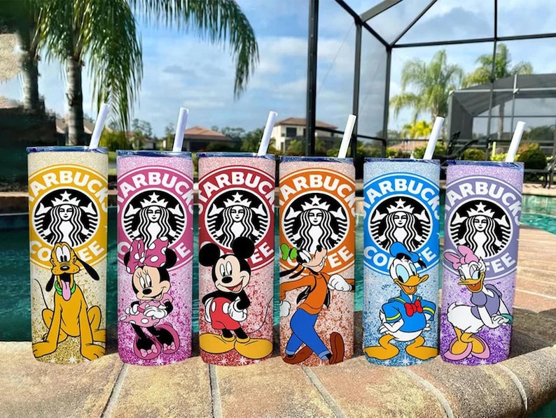 May include: Six glitter-covered tumblers with Disney character designs. Each tumbler features a Starbucks logo and a different character: Pluto, Minnie Mouse, Mickey Mouse, Goofy, Donald Duck, and Daisy Duck. Each has a straw.