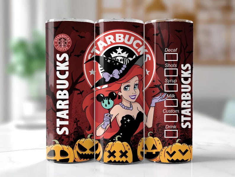 May include: A Starbucks tumbler featuring a Halloween-themed design. The tumbler showcases a cartoon of Ariel from The Little Mermaid in a witch costume, surrounded by pumpkins and bats. The Starbucks logo is prominently displayed.