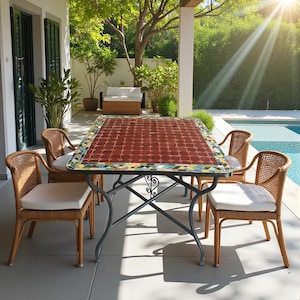 May include: An outdoor dining set comprising a rectangular table with a red tiled surface and decorative border. Four wicker chairs with white cushions are arranged around the table. The table has a dark metal base. The setting is on a patio.