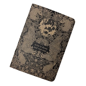 May include: A black notebook with a gold design of bats, flowers, and a full moon. The text "write it down and rest easy" is printed on the front cover.