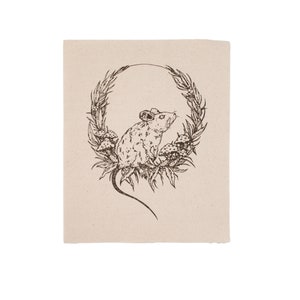 May include: A black and white line drawing of a mouse sitting in a wreath of leaves and mushrooms.