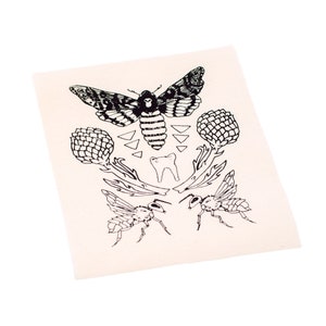 May include: Black and white illustration of a moth, two bees, and two artichoke plants. The moth has a skull-like face and the bees have wings and legs.