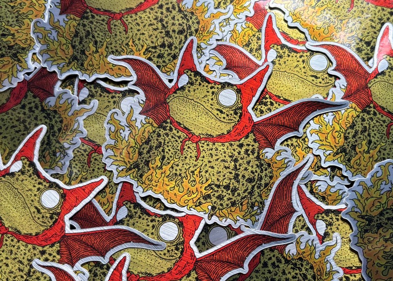 A die cut brushed silver metallic sticker of a full color toad in a devil costume with wings and flames.