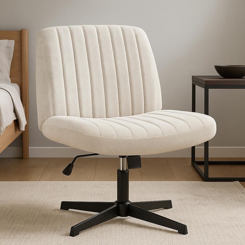 May include: Cream-colored office chair with a ribbed back and seat. The chair has a black, five-star base and a lever for height adjustment. The chair is on a light-colored rug.