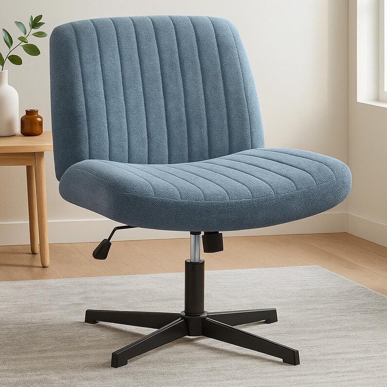 May include: A blue upholstered office chair with a ribbed back and seat. The chair has a black, five-star base and a height-adjustable mechanism. The chair is designed for comfort and support, suitable for a home office or workspace.